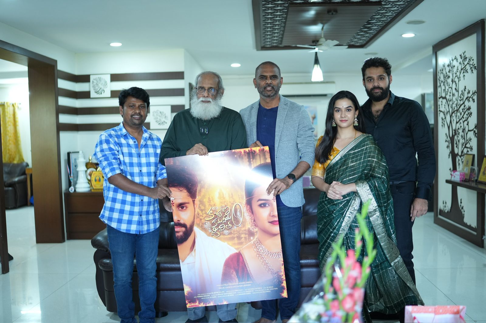 V. Vijayendra Prasad with the producer and lead pair holding the Kalyanam Kamaniyam Jeevitam poster